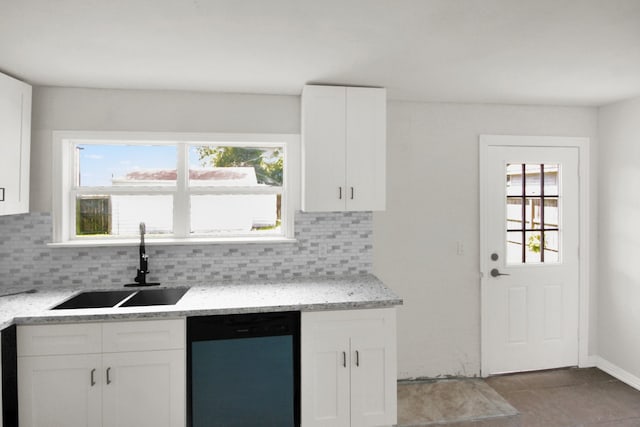 1101 2nd Ave N, Texas City, TX 77590 - kitchen featuring dishwashing machine, a sink, tasteful backsplash, and white cabinets