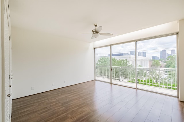 5050 Woodway Dr Unit 3M, Houston, TX 77056 - spare room featuring wood finished floors, ceiling fan, and a city view