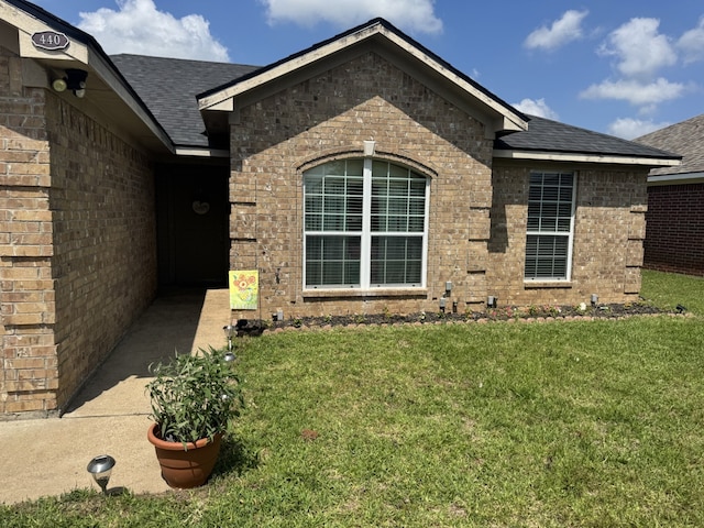 440 Maggie Cir, Flint, TX 75762 - property entrance with a lawn, brick siding, and a shingled roof