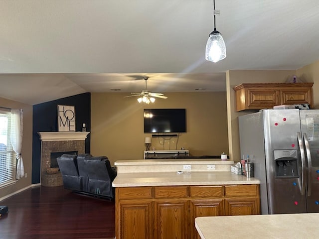 440 Maggie Cir, Flint, TX 75762 - kitchen with stainless steel refrigerator with ice dispenser, open floor plan, brown cabinetry, a peninsula, and light countertops