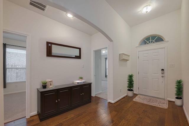 9715 Deborah Colony Ln, Humble, TX 77396 - entrance foyer featuring arched walkways, dark wood-style flooring, and baseboards