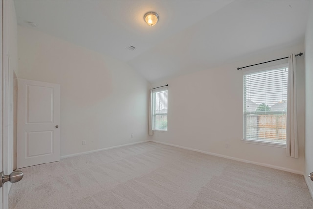 9715 Deborah Colony Ln, Humble, TX 77396 - spare room featuring lofted ceiling, light carpet, and baseboards