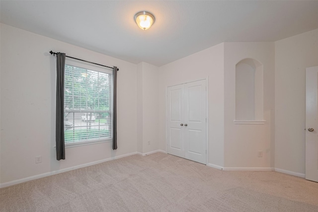 9715 Deborah Colony Ln, Humble, TX 77396 - unfurnished bedroom featuring light colored carpet, a closet, and baseboards