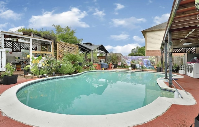 15133 Elstree Dr, Channelview, TX 77530 - view of swimming pool featuring a gazebo, a fenced backyard, washer / dryer, and a patio