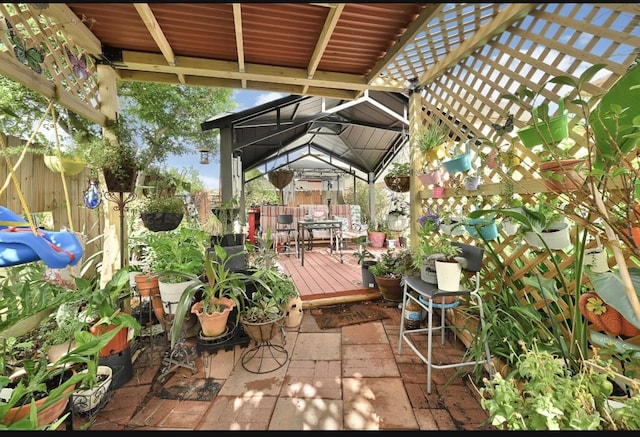 15133 Elstree Dr, Channelview, TX 77530 - fenced backyard featuring a gazebo, a wooden deck, and outdoor dining area