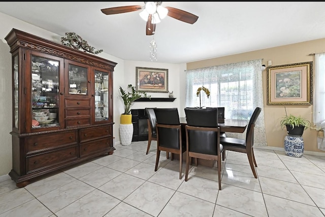 15133 Elstree Dr, Channelview, TX 77530 - dining area with a ceiling fan, light tile patterned flooring, and baseboards