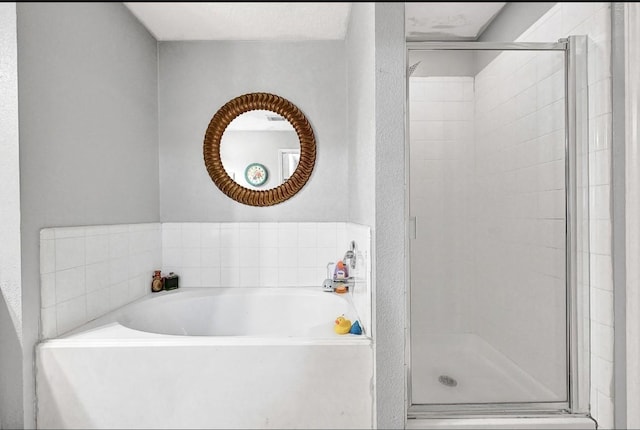 15133 Elstree Dr, Channelview, TX 77530 - full bathroom with a stall shower, a bath, and a textured wall