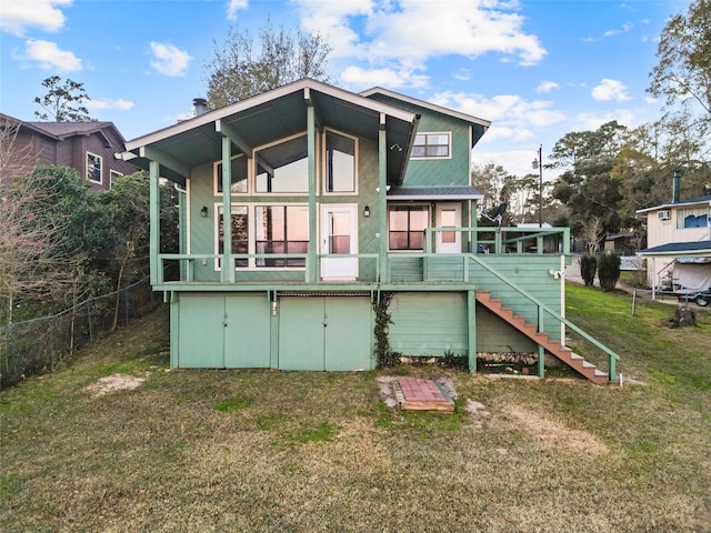 283 Sam Loop, Houston Loop, Point Blank, TX 77364 - rear view of property with a sunroom, stairway, and a lawn