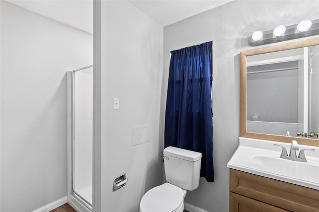 283 Sam Loop, Houston Loop, Point Blank, TX 77364 - bathroom with baseboards, vanity, toilet, and a stall shower