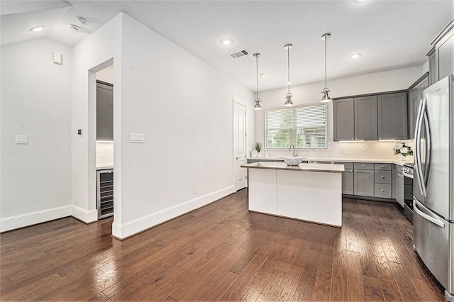 1266 N Post Oak Rd Unit B, Houston, TX 77055 - kitchen featuring appliances with stainless steel finishes, gray cabinets, a kitchen island, beverage cooler, and dark wood finished floors