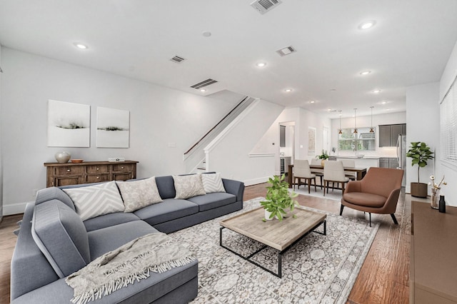 1266 N Post Oak Rd Unit B, Houston, TX 77055 - living room with wood finished floors, stairway, and recessed lighting