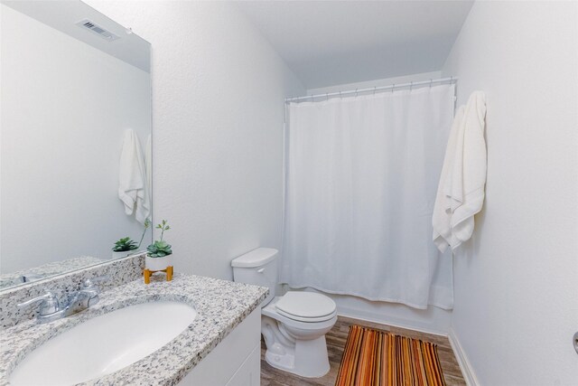 940 Cedar Point Dr, Livingston, TX 77351 - full bath with vanity, toilet, wood finished floors, and baseboards