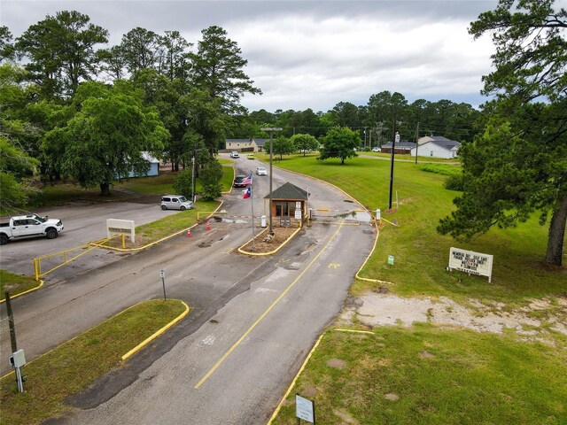 940 Cedar Point Dr, Livingston, TX 77351 - view of asphalt road with curbs and view of scattered trees