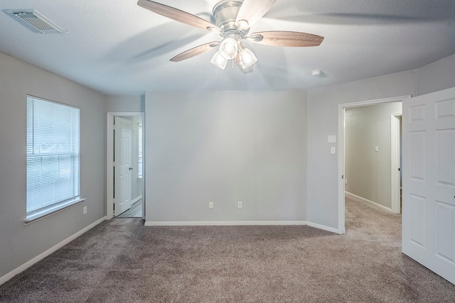 21106 Scenic Bluff Ln, Humble, TX 77338 - spare room featuring carpet, ceiling fan, and baseboards