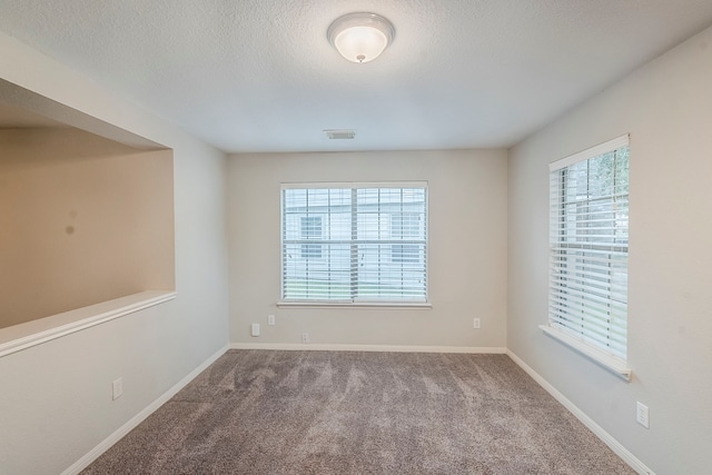 21106 Scenic Bluff Ln, Humble, TX 77338 - carpeted empty room featuring baseboards and a textured ceiling