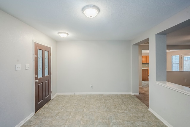 21106 Scenic Bluff Ln, Humble, TX 77338 - foyer with baseboards and a textured ceiling