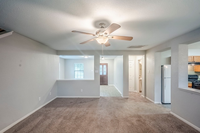 21106 Scenic Bluff Ln, Humble, TX 77338 - unfurnished living room with ceiling fan, light colored carpet, a textured ceiling, and baseboards
