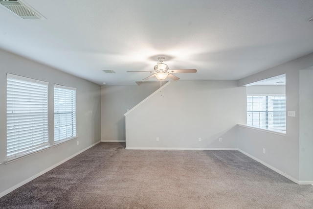 21106 Scenic Bluff Ln, Humble, TX 77338 - unfurnished living room featuring a ceiling fan, carpet flooring, and baseboards