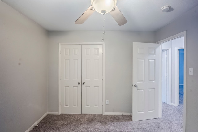21106 Scenic Bluff Ln, Humble, TX 77338 - unfurnished bedroom with carpet, a closet, baseboards, and ceiling fan
