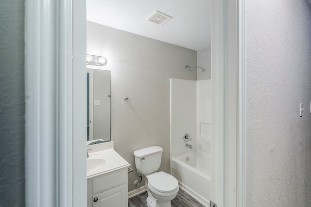 21106 Scenic Bluff Ln, Humble, TX 77338 - bathroom with vanity, toilet, tub / shower combination, wood finished floors, and a textured wall