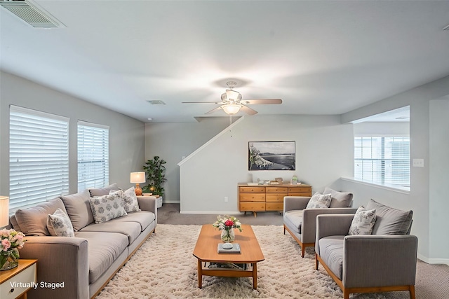 21106 Scenic Bluff Ln, Humble, TX 77338 - living area featuring light colored carpet, a ceiling fan, plenty of natural light, and baseboards