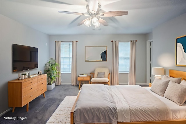 21106 Scenic Bluff Ln, Humble, TX 77338 - bedroom with dark colored carpet, baseboards, and ceiling fan