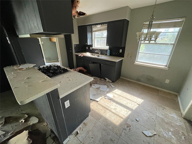 3225 Bostic St, Houston, TX 77093 - kitchen with gas stovetop, dark cabinetry, baseboards, backsplash, and a sink