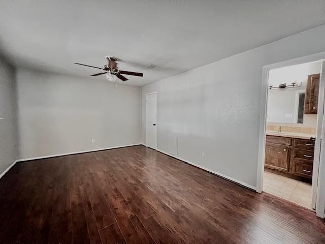 9015 Stone Brook Ln, Houston, TX 77040 - unfurnished bedroom with wood finished floors, ensuite bath, baseboards, and a ceiling fan