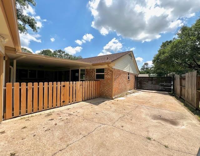 9015 Stone Brook Ln, Houston, TX 77040 - view of home's exterior featuring brick siding and a gate