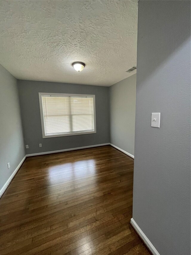 4115 Groton Dr, Houston, TX 77047 - unfurnished room with wood finished floors, baseboards, and a textured ceiling