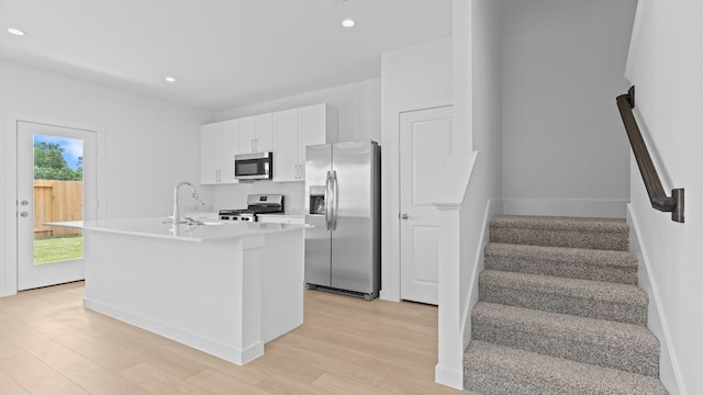 1823 Revolution Way, Missouri City, TX 77489 - kitchen featuring appliances with stainless steel finishes, recessed lighting, white cabinets, light wood-type flooring, and light countertops