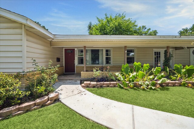 4301 Ascot Ln, Houston, TX 77092 - property entrance with a porch and a lawn