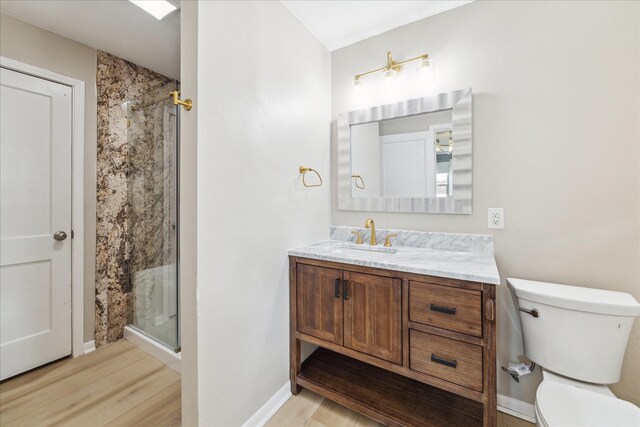 4301 Ascot Ln, Houston, TX 77092 - bathroom with toilet, vanity, a stall shower, and wood finished floors