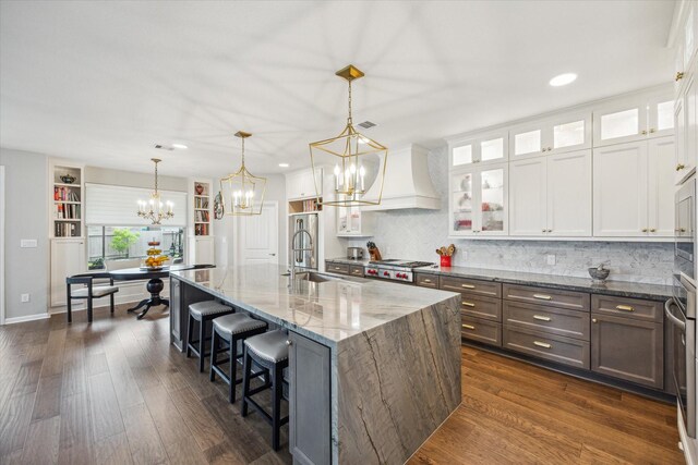 29303 Kellys Falls Ct, Katy, TX 77494 - kitchen with a sink, a chandelier, light stone countertops, white cabinetry, and recessed lighting