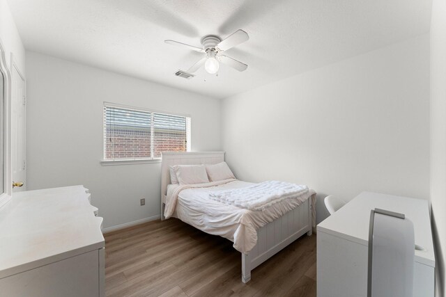 6107 Villa Hills Dr, Houston, TX 77066 - bedroom with wood finished floors, ceiling fan, and baseboards