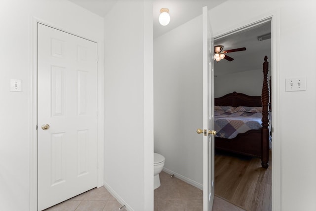6107 Villa Hills Dr, Houston, TX 77066 - ensuite bathroom featuring toilet, tile patterned flooring, a ceiling fan, and baseboards