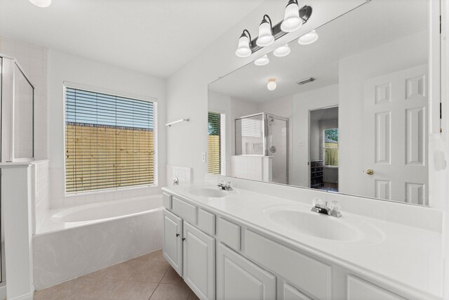 6107 Villa Hills Dr, Houston, TX 77066 - bathroom featuring a garden tub, a shower stall, double vanity, and tile patterned floors