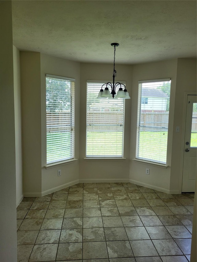 19734 Logan Briar Dr, Tomball, TX 77375 - unfurnished dining area featuring a chandelier, baseboards, and light tile patterned floors