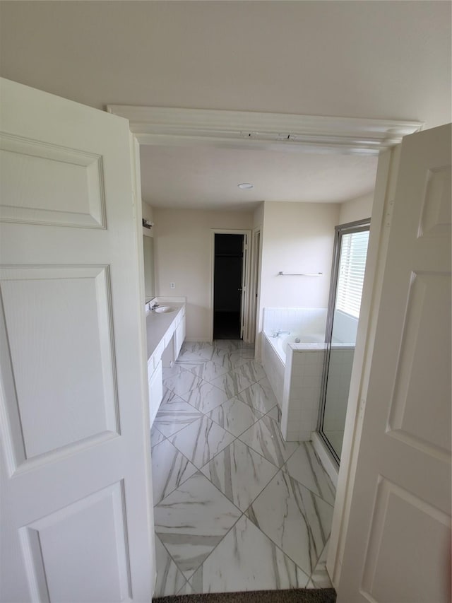 19734 Logan Briar Dr, Tomball, TX 77375 - bathroom featuring a bath, marble look tile flooring, and vanity