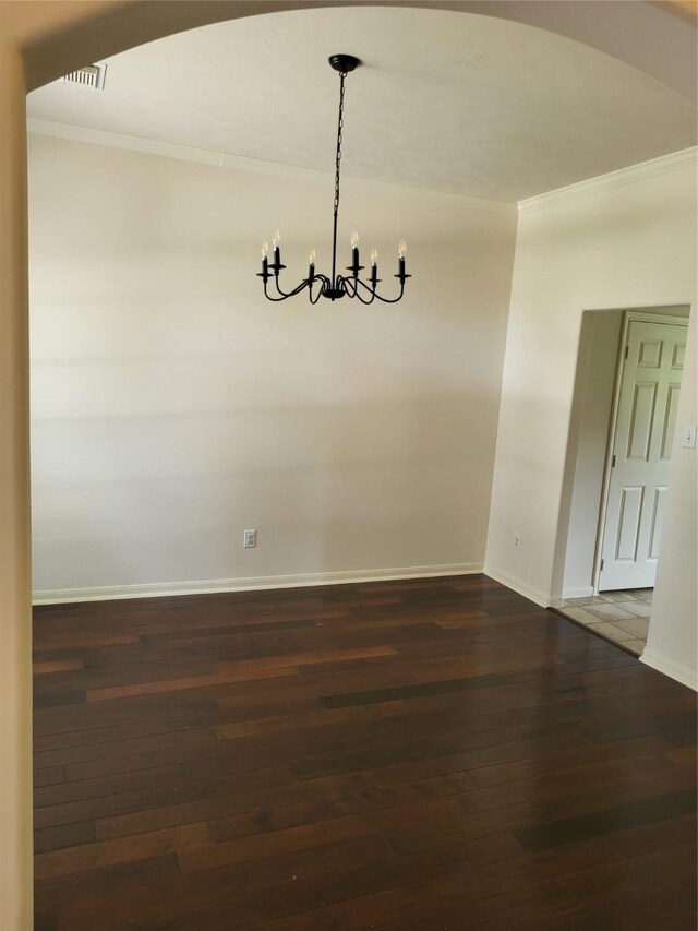 19734 Logan Briar Dr, Tomball, TX 77375 - unfurnished dining area with crown molding, a chandelier, dark wood-style floors, baseboards, and arched walkways