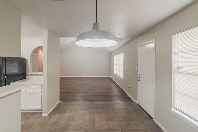 5819 Bridgegate Dr, Spring, TX 77373 - unfurnished dining area with tile patterned floors, arched walkways, and baseboards