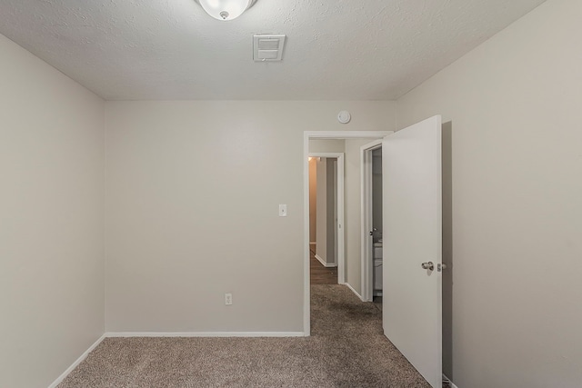 5819 Bridgegate Dr, Spring, TX 77373 - empty room featuring dark carpet, baseboards, a smoke detector, and a textured ceiling