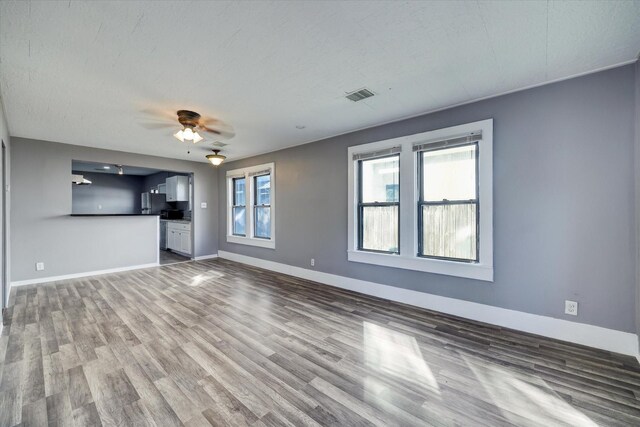 1507 Laird St, Houston, TX 77008 - unfurnished living room featuring wood finished floors, baseboards, and ceiling fan