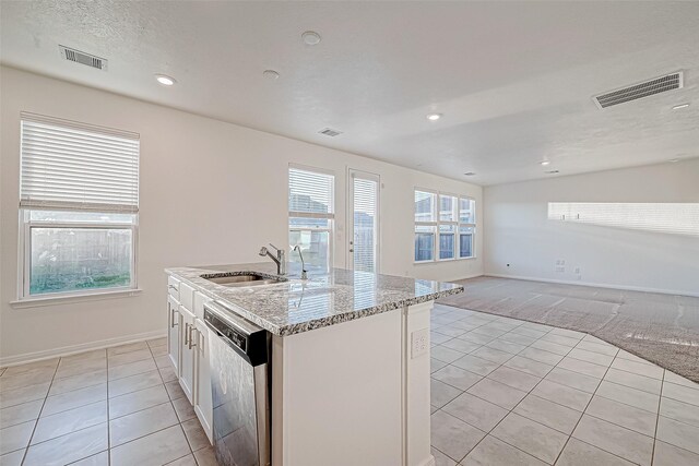 7106 Escondido Dr, Rosharon, TX 77583 - kitchen featuring dishwasher, a sink, light tile patterned flooring, light stone countertops, and recessed lighting