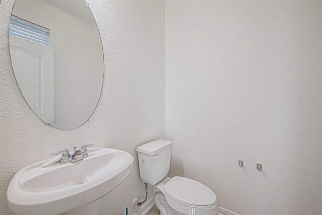 7106 Escondido Dr, Rosharon, TX 77583 - bathroom with a sink, toilet, and baseboards