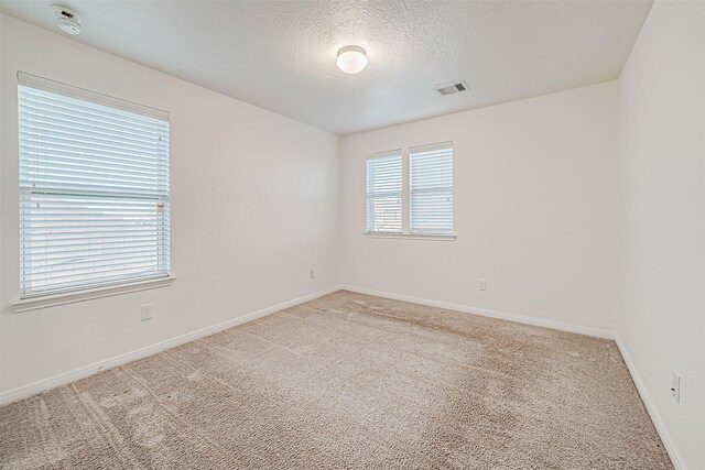7106 Escondido Dr, Rosharon, TX 77583 - empty room featuring carpet flooring, baseboards, a smoke detector, and a textured ceiling