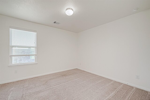 7106 Escondido Dr, Rosharon, TX 77583 - unfurnished room with baseboards, light carpet, a textured ceiling, and a smoke detector