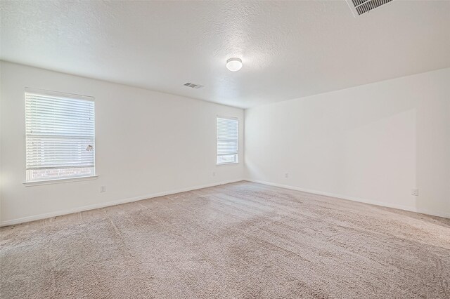 7106 Escondido Dr, Rosharon, TX 77583 - unfurnished room with a textured ceiling, light colored carpet, and baseboards