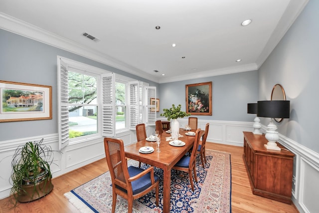 3820 Purdue St, Houston, TX 77005 - dining area with light wood-style floors, crown molding, wainscoting, recessed lighting, and a decorative wall