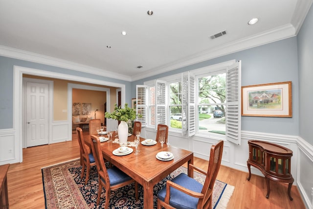 3820 Purdue St, Houston, TX 77005 - dining area featuring ornamental molding, light wood-style floors, wainscoting, and a decorative wall